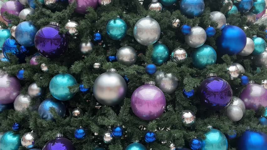 Big Christmas tree in shopping mall. Holiday decorations. Big elegant Christmas tree indoors at a shopping center. Vertical video