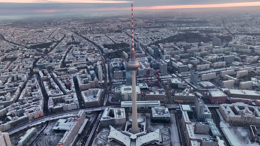 City of Berlin, Germany from above. Aerial winter cityscape view at sunrise or sunset, showing architectural landmarks Oberbaum Bridge, TV Tower and Berlin Cathedral in winter. 
