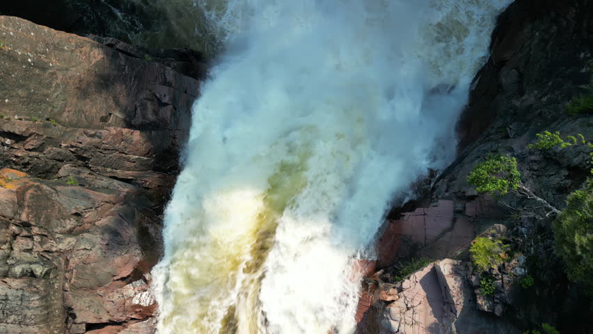An impressive aerial rotating view of Aguasabon Falls spilling into Aguasabon Gorge near Terrace Bay, Ontario, Canada on the northern shore of Lake Superior.