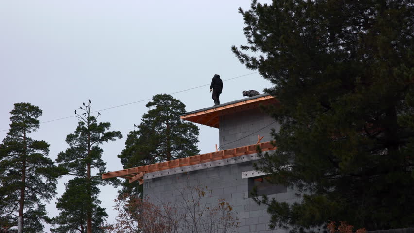 Mystery Figure Observes From Red Roof Top, Person In Silhouette Surveys Wilderness From Rustic Cabin Edge . Media