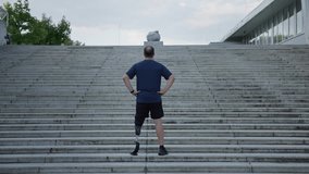 Man with a disability focusing and preparing for a running challenge, on the outdoor staircase, using specific prosthetic equipment - Powered by Shutterstock - Get 15% off with code: PIKWIZARD15