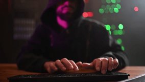 Anonymous computer programmer in a hoodie typing on a keyboard. Dark room with server racks and flashing lights representing cybersecurity - Powered by Shutterstock - Get 15% off with code: PIKWIZARD15