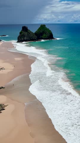 Seascape volcano mountains and beach at archipelago of Fernando de Noronha Brazil. Tropical volcano islands at Fernando de Noronha archipelago. Vacation travel. Tropical destination.