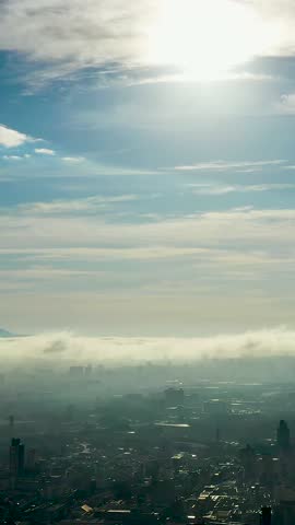 Foggy morning. Rays of sun above the clouds. Sunlight weather. Sunrise at city. Panorama aerial view of fog morning landscape at downtown Sao Paulo Brazil.