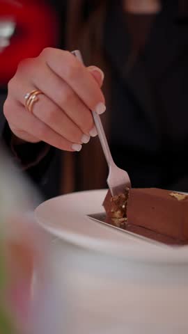 A woman eats a chocolate dessert. The concept of tasting dessert.