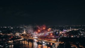 Colorful fireworks display exploding above Memorial Bridge and Chao Phraya River with Bangkok city during night in Festive New Year celebration - Powered by Shutterstock - Get 15% off with code: PIKWIZARD15