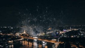 Colorful fireworks display exploding above Memorial Bridge and Chao Phraya River with Bangkok city during night in Festive New Year celebration - Powered by Shutterstock - Get 15% off with code: PIKWIZARD15
