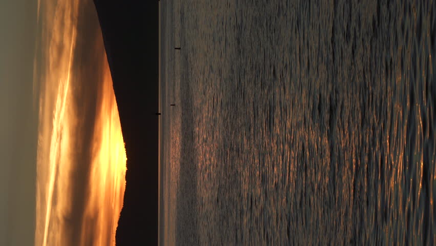 English Bay Sunset Swim Vancouver vertical video 4K UHD.A swimmer at sunset on English Bay. Vancouver, British Columbia, Canada. 4K, UHD. Vertical video.
