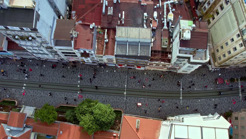 Daytime aerial view of Istiklal Street in Istanbul. Tram line, crowded pedestrian flow and historic buildings reflect the city’s cultural identity, tourism appeal and vibrant urban life.