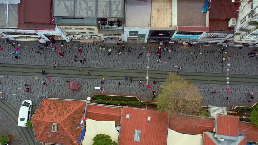 Daytime aerial view of Istiklal Street in Istanbul. Tram line, crowded pedestrian flow and historic buildings reflect the city’s cultural identity, tourism appeal and vibrant urban life.