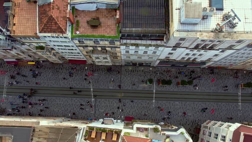 Daytime aerial view of Istiklal Street in Istanbul. Tram line, crowded pedestrian flow and historic buildings reflect the city’s cultural identity, tourism appeal and vibrant urban life.
