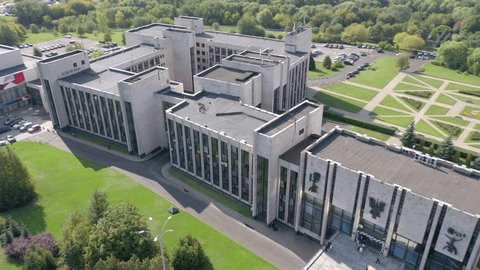 Drone Flying Diagonally Away Campus Building