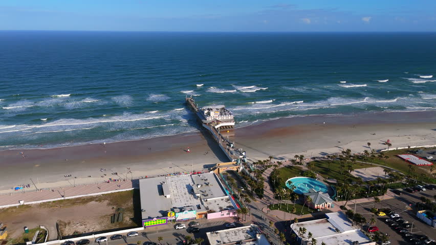 Top down drone view of Daytona Beach Florida pier over ocean