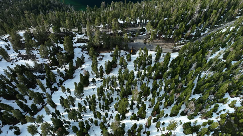 Aerial tilt reveal over the snowy Emerald bay, winter day at Lake Tahoe, USA