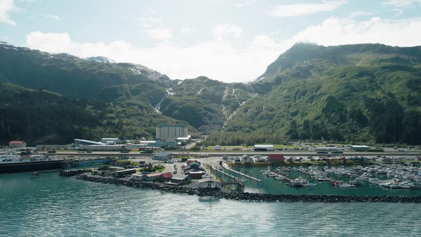 Aerial push in of the town of Whittier Alaska from the water.