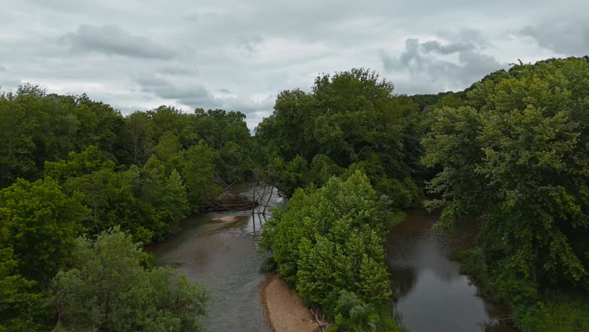 River Flowing Through A Densely Forested Area In Tagg Flats, Oklahoma, USA. - aerial shot