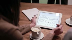 Business professionals analyzing charts on a tablet, collaborating in a modern office, discussing data insights, strategy, and teamwork for informed decisions. - Powered by Shutterstock - Get 15% off with code: PIKWIZARD15