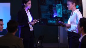 Corporate leadership team conducting a strategic presentation in a modern high-tech office. Female executives analyzing market data and digital business performance on a large monitoring screen. Profe - Powered by Shutterstock - Get 15% off with code: PIKWIZARD15