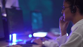 Professional technical support team managing customer service in a high-tech data center. Operators handling client communications and troubleshooting issues using digital interfaces during a night sh - Powered by Shutterstock - Get 15% off with code: PIKWIZARD15