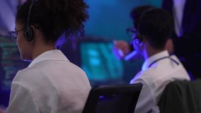 Professional technical support team managing customer service in a high-tech data center. Operators handling client communications and troubleshooting issues using digital interfaces during a night sh - Powered by Shutterstock - Get 15% off with code: PIKWIZARD15