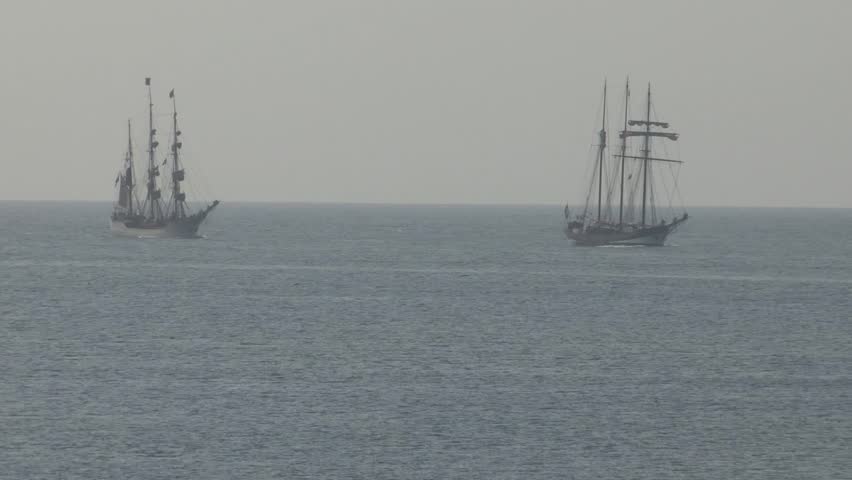 Two old Dutch sailing ships at sea 
