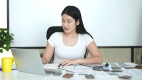 Designer working in office and making call on mobile phone. Female interior designer talking by mobile phone at desk in office. - Powered by Shutterstock - Get 15% off with code: PIKWIZARD15