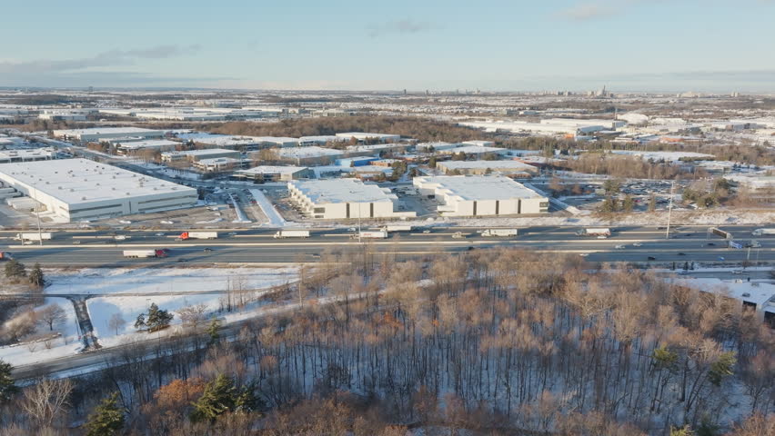 Aerial view of HWY 401 in snowy Mississauga, industrial area, winter day