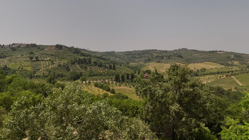Aerial views of houses on a hill in Impruneta near Florence, Italy, featuring the rolling hills of the scenic Tuscan landscape. On a beautiful summers day.