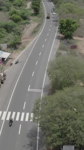 Aerial Vertical Drone View of Bikers Riding on Scenic Winding Road