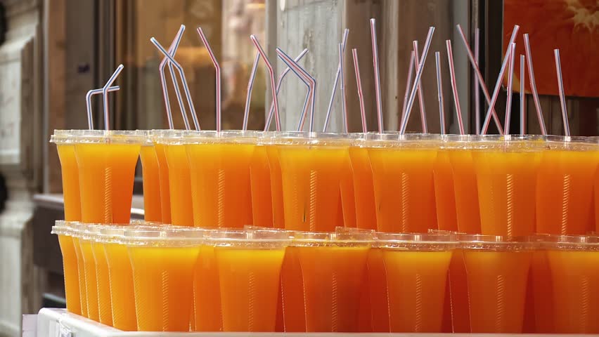 Fresh Orange Juice in Plastic Cups with Lids and Straws
