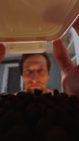 Man Reaching Into Coffee Bean Jar While Camera Films from Inside — Hands Coming Toward Lens, Warm Colored Interior, Slow Motion.