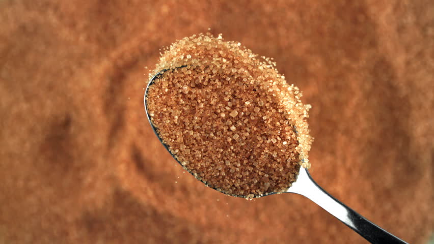 Cane sugar pours out of a spoon. Filmed on a high-speed camera at 1000 fps. High quality FullHD footage