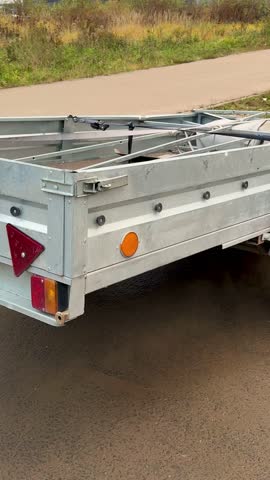 Closeup Of Worn Trailer Parts, Detail View Of Aged Trailer With Rusted Components And Hitch, Close Examination Of Weathered Trailer Showing Corroded Parts And Worn-out Taillight.