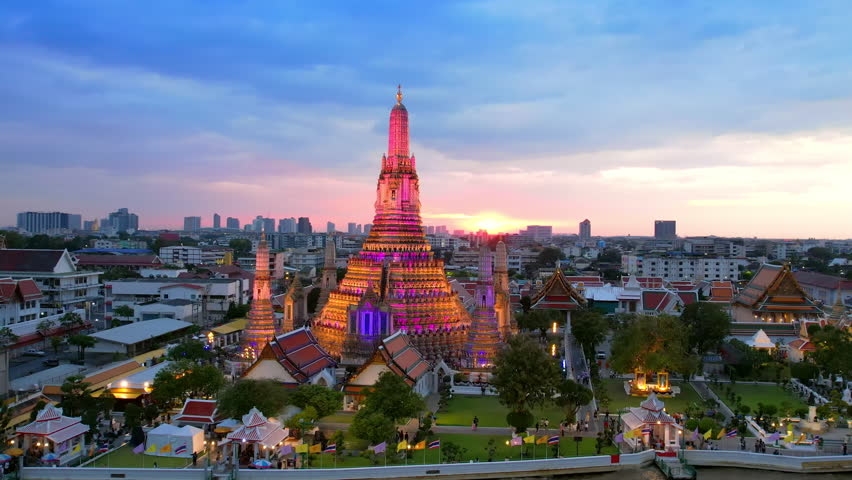 Orbit around illuminated Wat Arun Temple at Night