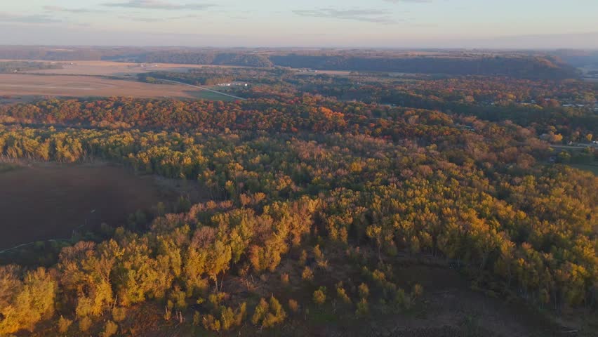 Warm sunrise tones illuminate quiet Driftless Area wetlands and river.