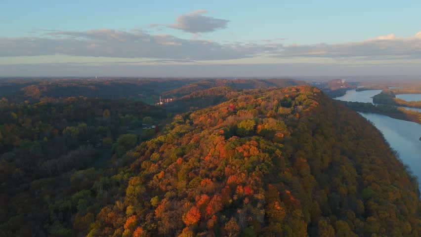 Golden sunrise light over bluffs, forest, and a lazy river in the Driftless Area. in the Minnesota Wisconsin boarder