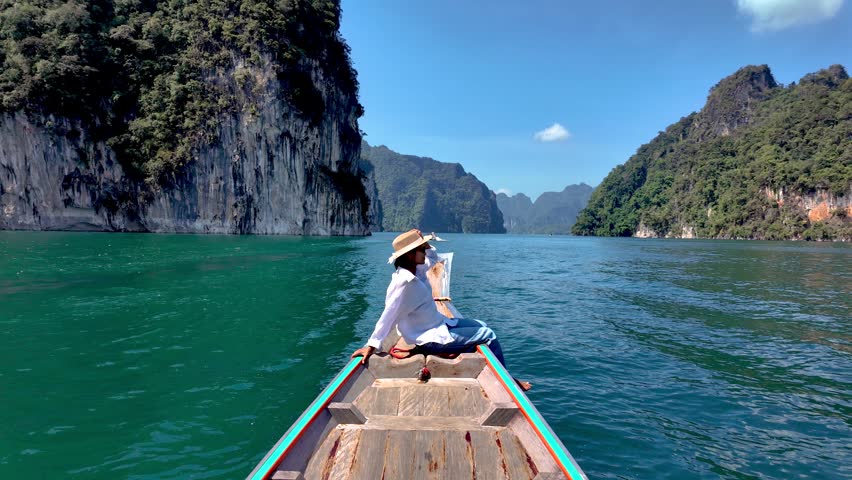 Explore the stunning Khao Sok National Park with a serene boat ride. Experience the vibrant turquoise waters surrounded by lush cliffs and tranquil nature. A perfect escape into paradise.