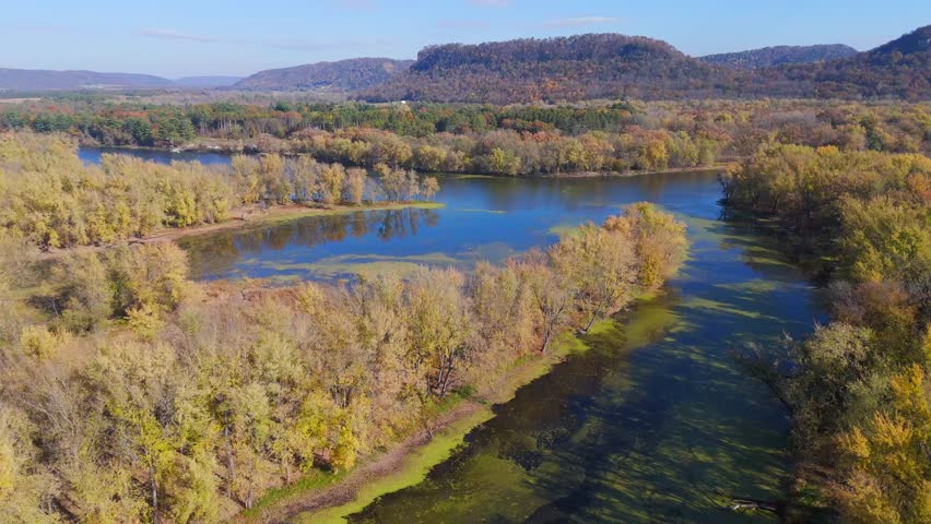 Sunny autumn day over a floodplain forest with river islands and calm channels in the Driftless Area.