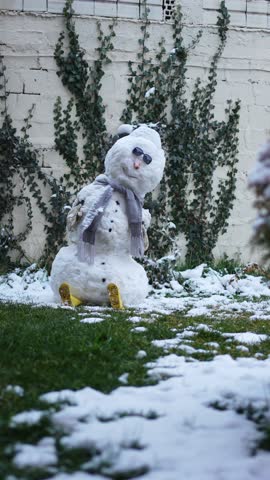 Charming snowman with scarf and hat in a winter garden setting