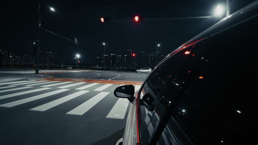 Nighttime car journey along a wide road in Incheon with illuminated high-rise skyline