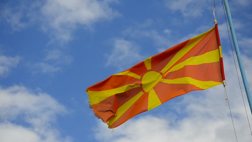 Flag of Macedonia waving on the bright blue sky clouds, LOOP