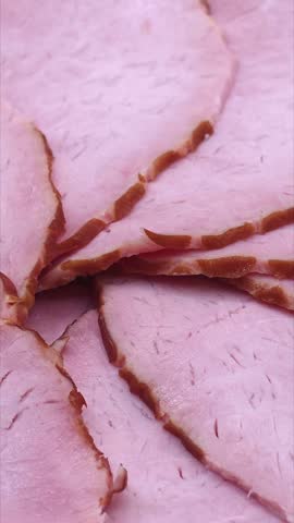 Sliced pork ham texture close-up. Food background, vertical video
