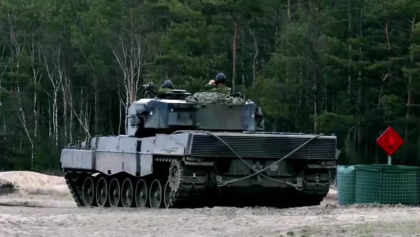 Polish Leopard 2 tank conducting military training on a shooting range, demonstrating armored warfare capability, NATO ground forces operations, and modern battle tank exercises.
