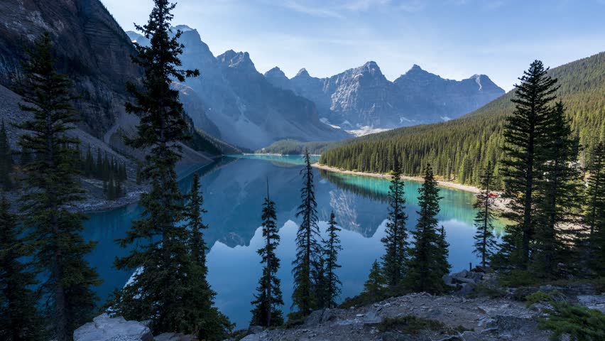 Banff National Park Moraine Lake sunrise time lapse with shadows revealing vivid turquoise water. Alberta, Canada.