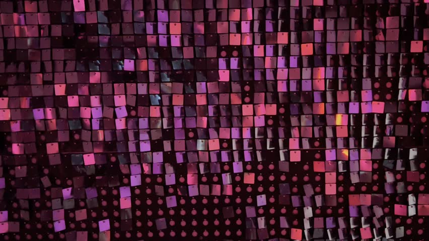 new years year celebration shimmering background featuring decorative wall covered in hundreds of small shiny square sequins pink purple red metallic tiles reflect light creating festive glam atmosphere textured surface shows regular grid arrangement of reflective plastic spangles modern interior design element event decoration backdrop nightlife party aesthetic luxury sparkling detail close up view fashion industry materials glitz glamour celebration mood disco style ornamentation shimmering effect