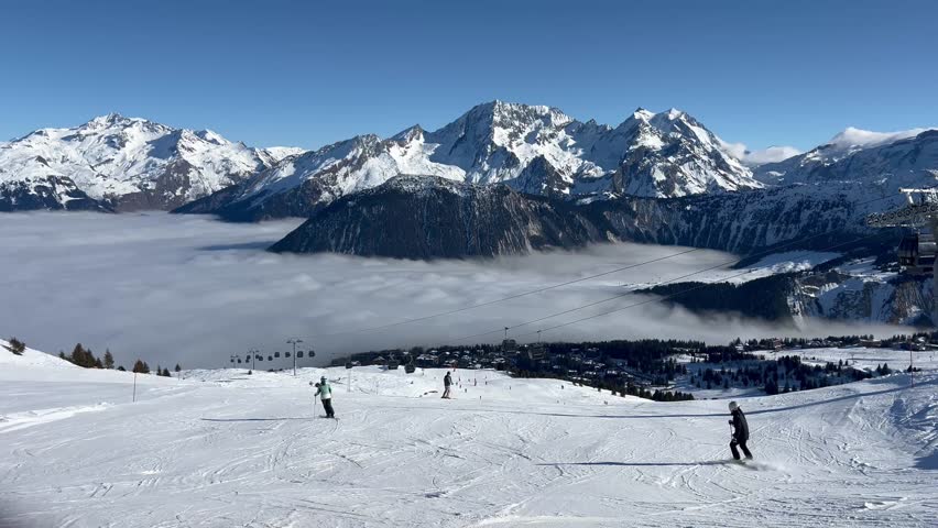 Aerial view Courchevel ski resort under clouds by winter, Rhône alps, France, Mont Blanc mountain in the background