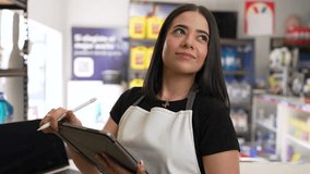 Hispanic female store owner using a digital tablet for inventory management in her retail shop - Powered by Shutterstock - Get 15% off with code: PIKWIZARD15