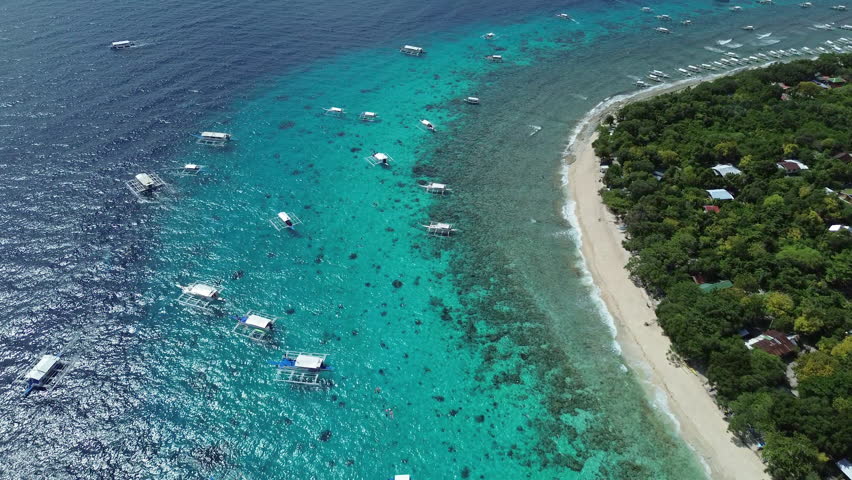 Aerial view of tropical island Balicasag beach, turquoise waters and coral reefs, Philippines, 4k
