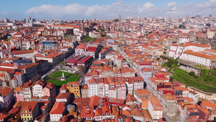 Old Porto traditional houses with terracotta roofs, medieval alleys, churches, and gardens, Establishing drone shot