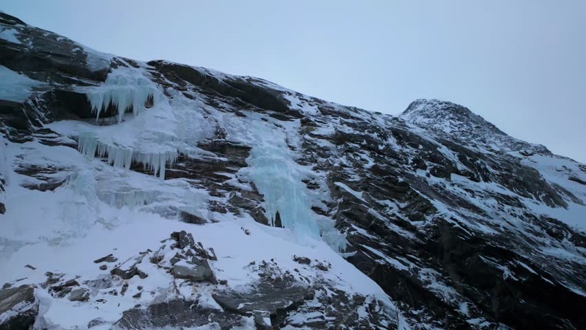 Rocky Mountains Covered With Ice Under Overcast Sky In Nuuk Fjord In Greenland. POV Shot